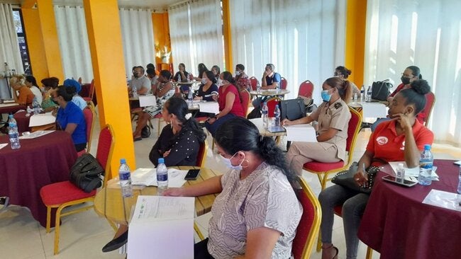 Photo of people sitting on a classroom taking a training