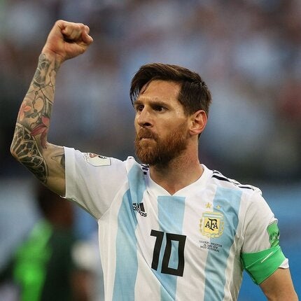 Lionel Messi with Argentinian soccer jersey clenching fist in the air