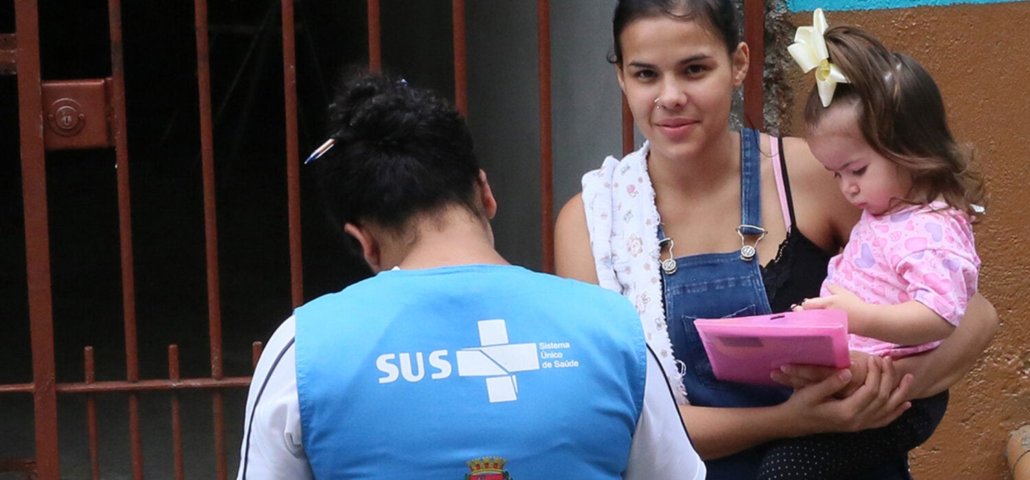 woman in a door holding a child