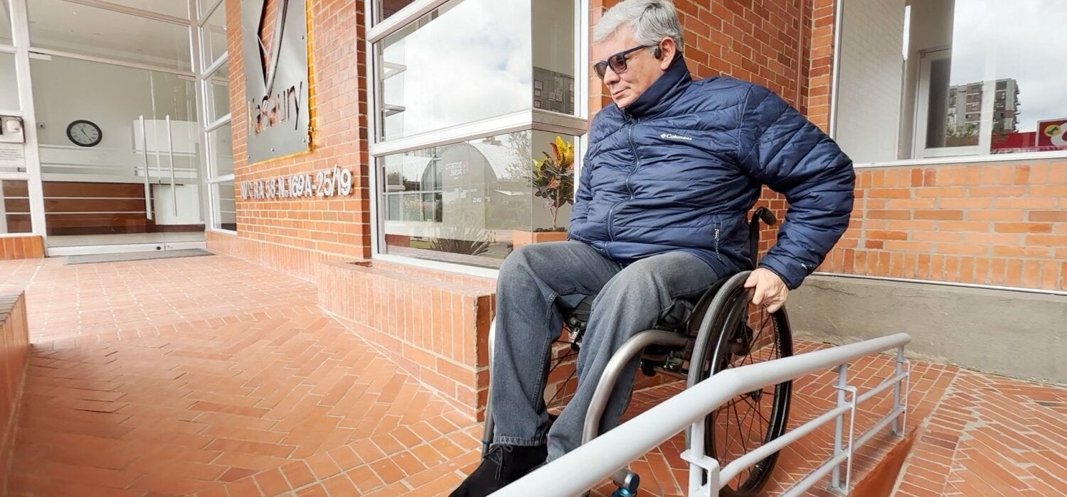 Ricardo on a wheelchair navigating a ramp