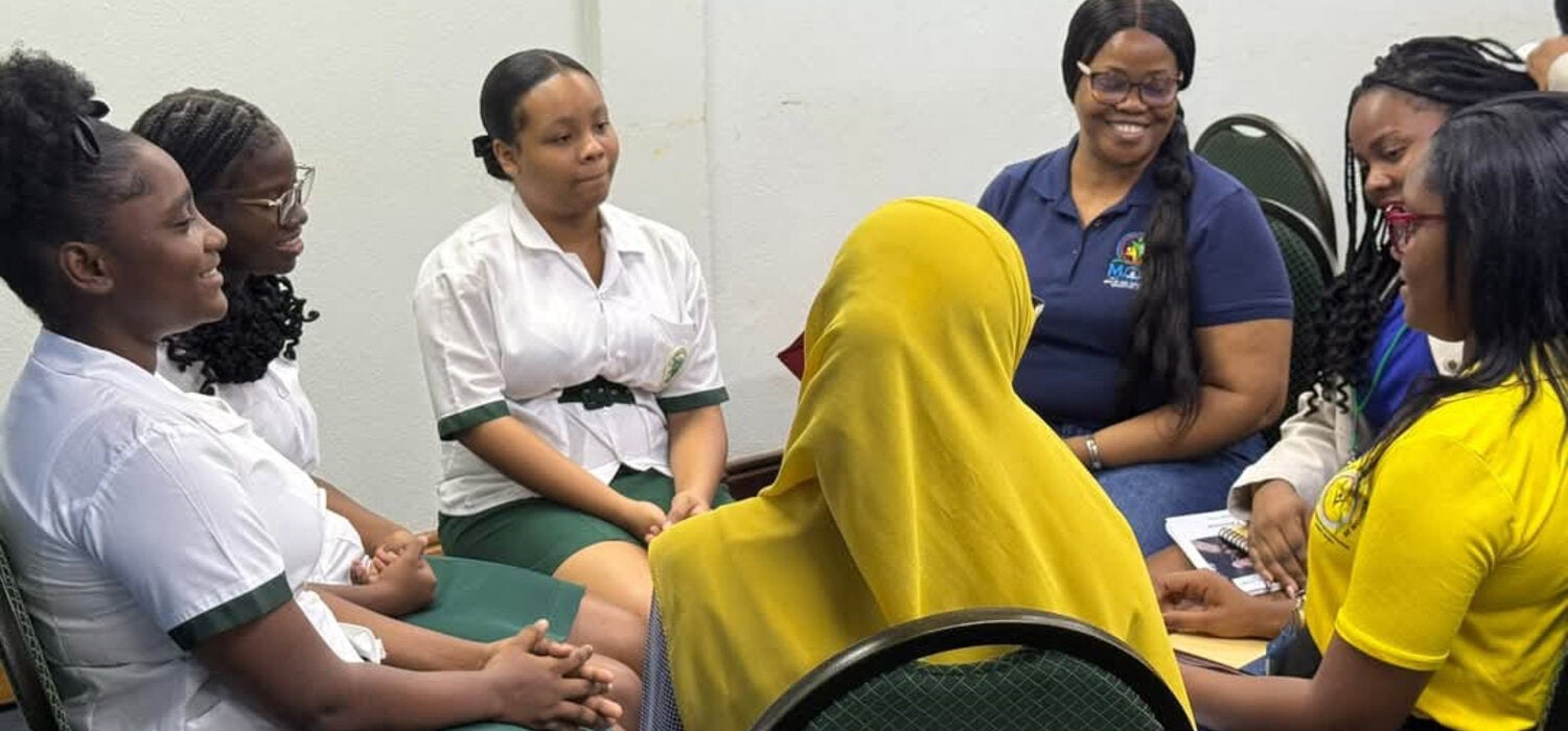 Youth around the table with adults addressing issues