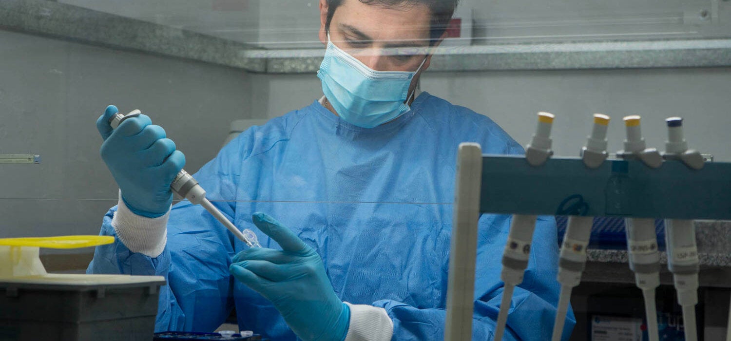 technician in protective gear testing and tracking down viruses
