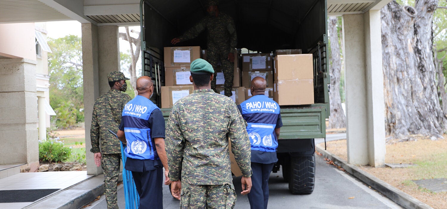 PAHO and Barbados Defence Force personnel loading truck with donated items