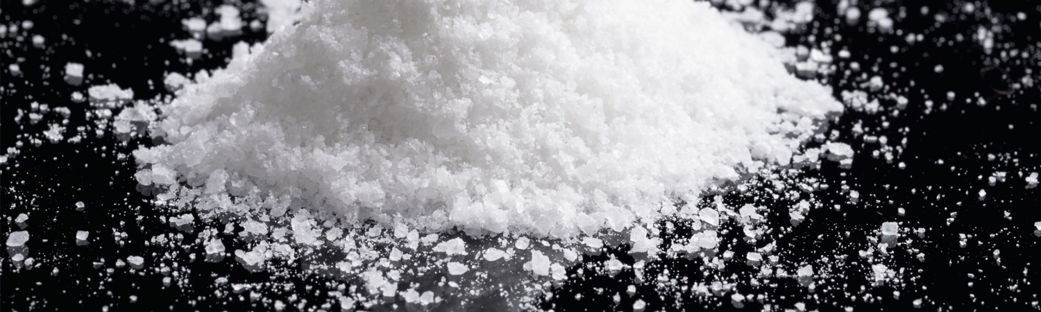 grains of salt on a black countertop
