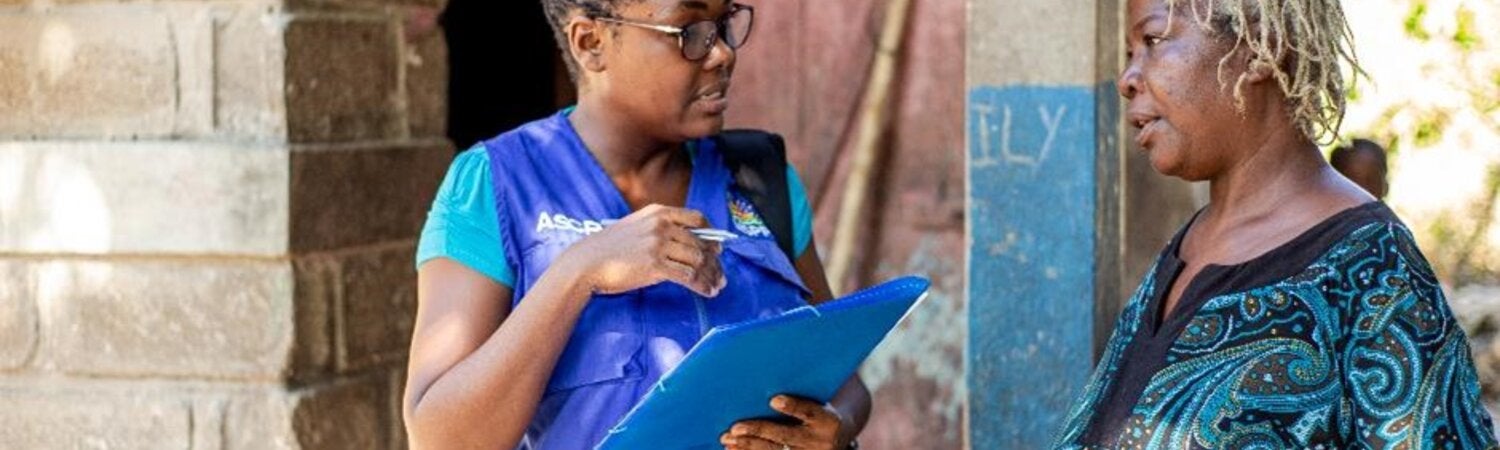 PAHO staff speaking with lady in Haiti