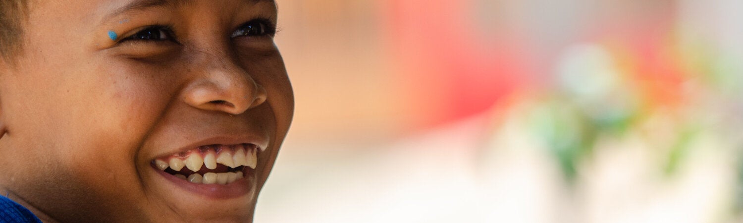 Indigenous girl smiling, with a blurred background