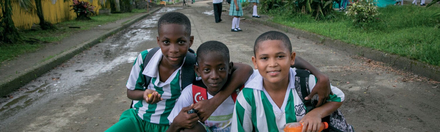 Happy boys playing in the street, posing to the camera
